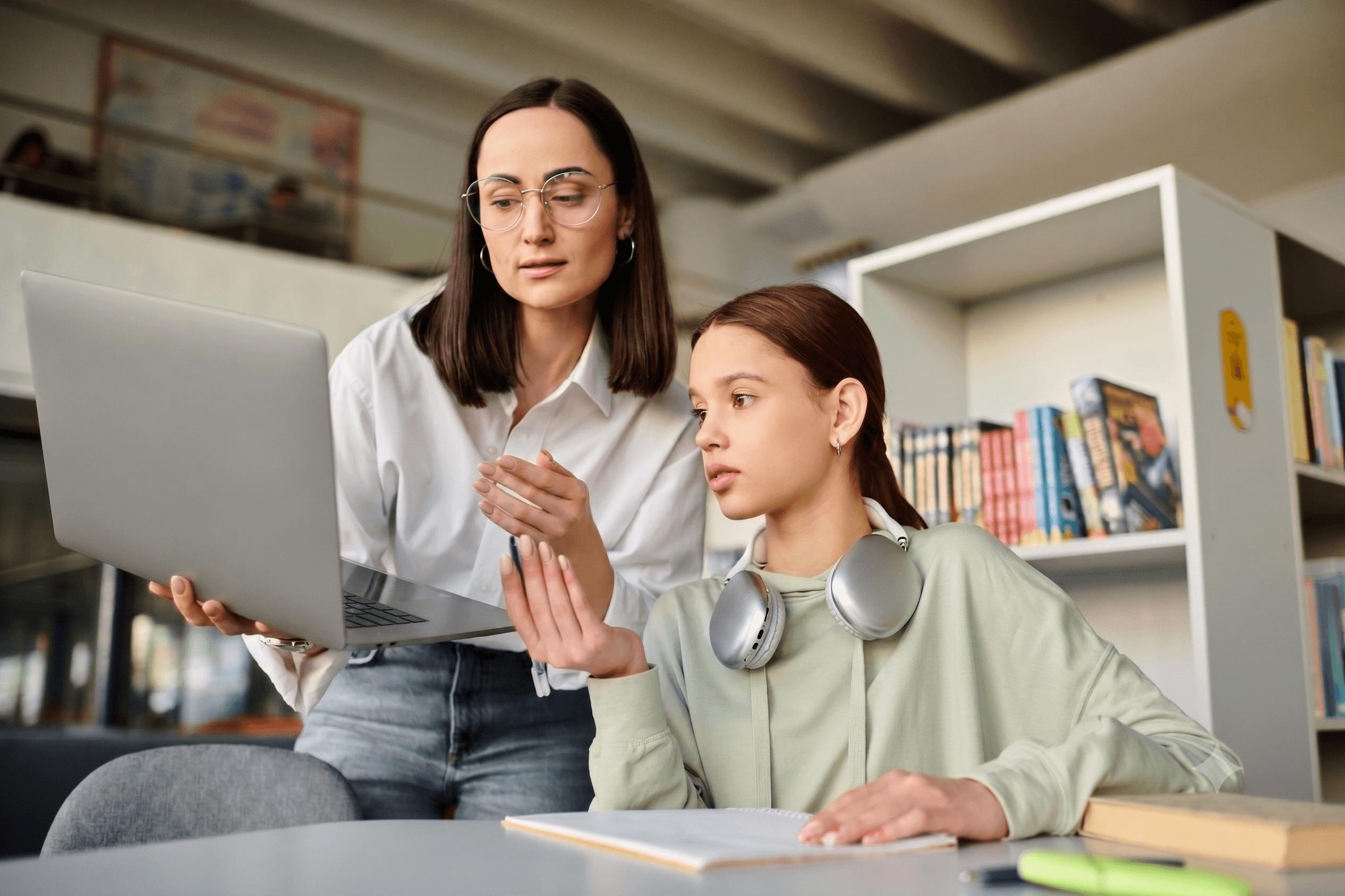 Tutor and student reviewing work on a laptop